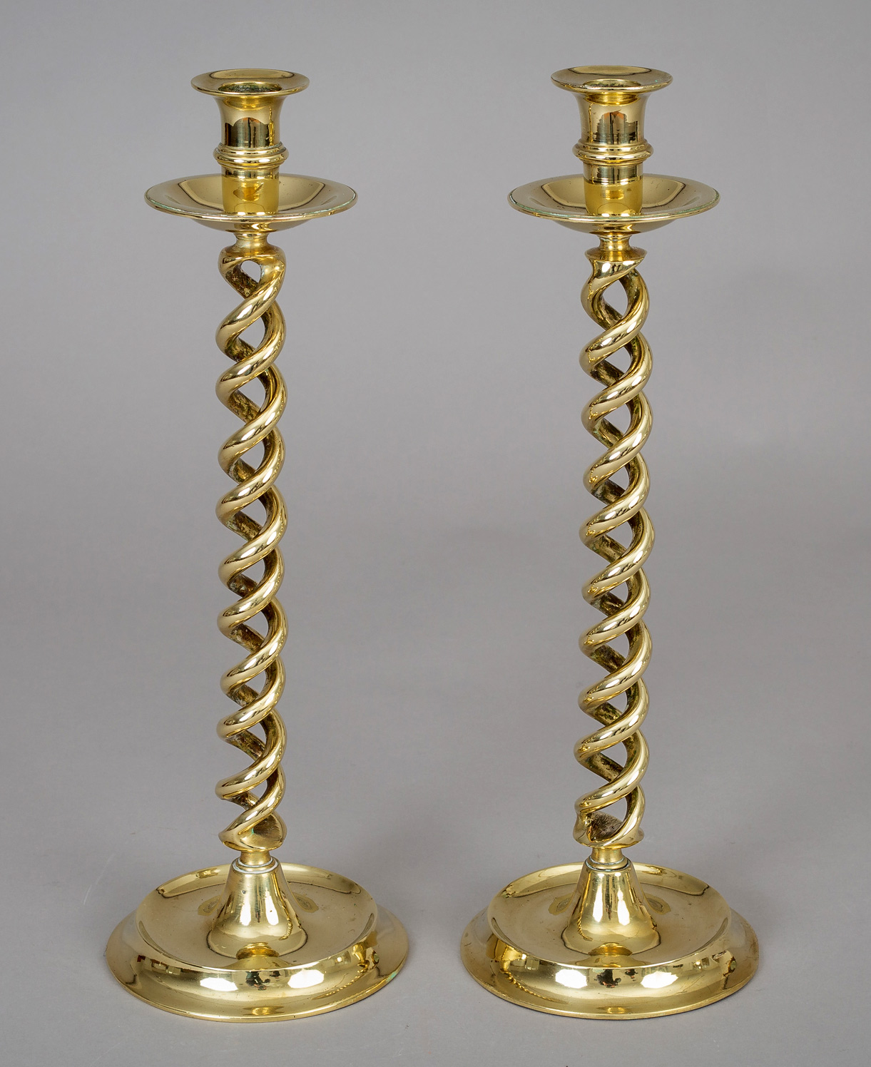 Lot - PAIR OF ENGLISH BRASS 'BEEHIVE' CANDLESTICKS AND A BRASS OIL LAMP  Height of candlesticks: 11 3/4 in. (29.8 cm.), Height of lamp: 11 1/2 in.  (29.2 cm.)
