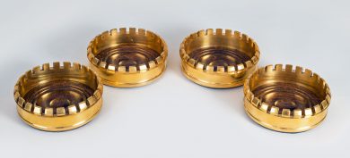 Four Gilded Brass Bottle Coasters